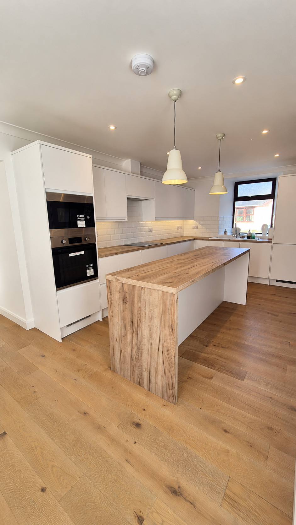 Kitchen with timber-effect island within the Glenloig downstairs renovation