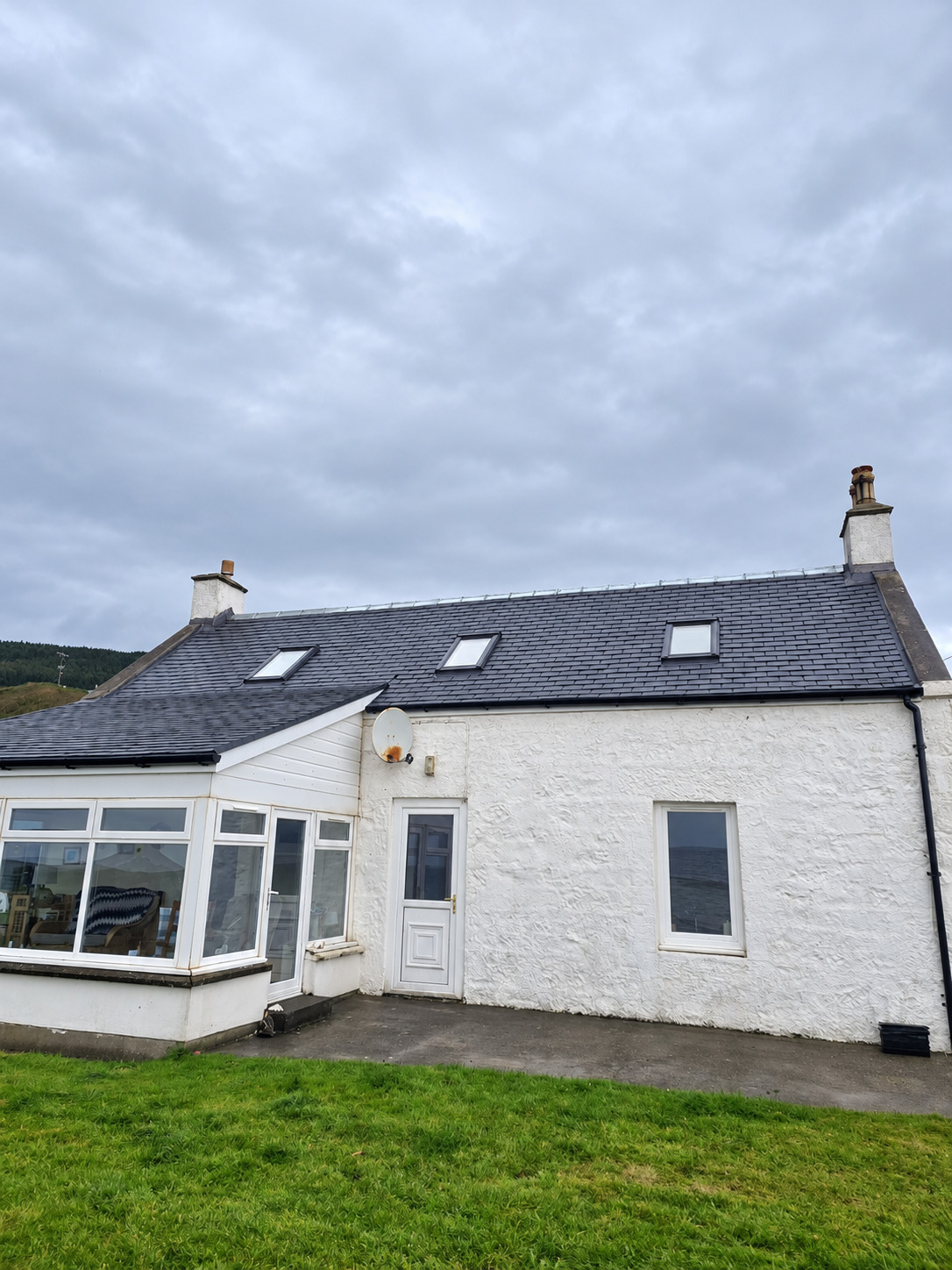 Completed roof replacement on a white cottage in Kildonan, Isle of Arran